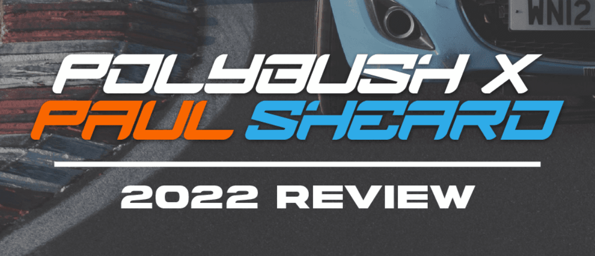 Text overlay reading "polygush x paul sheard 2022 review" on an image showing a close-up of a racing car's front end visible next to stacked racing tyres.